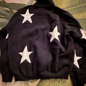 Black Coraline sequel sweater with white stars
